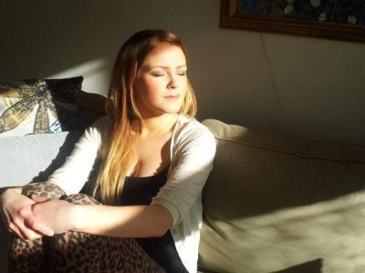 Woman facing the sun with closed eyes